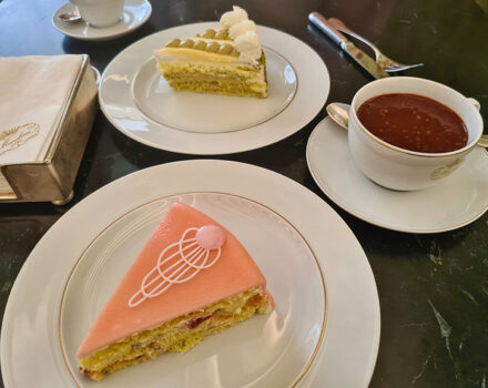 slices of cake and a cup of hot chocolate on a marble table